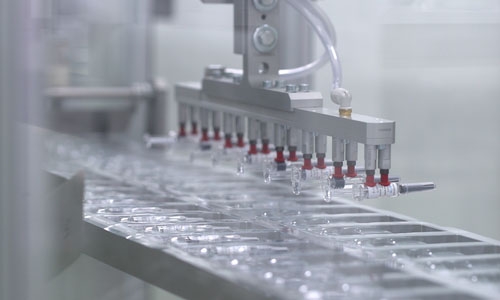 Syringes are processed on a high-speed automated assembly line.