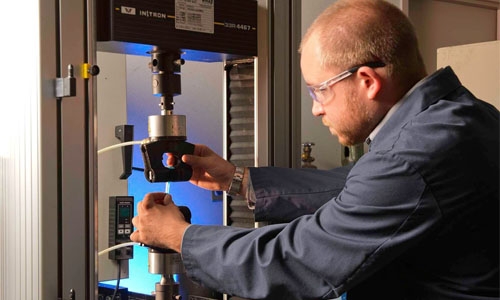An application engineer performs various mechanical tests on a substrate using an instron machine.